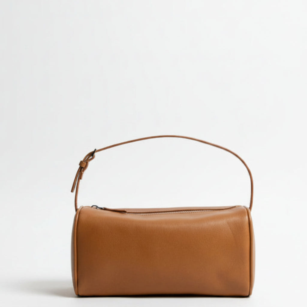 Brown leather handbag on a white background