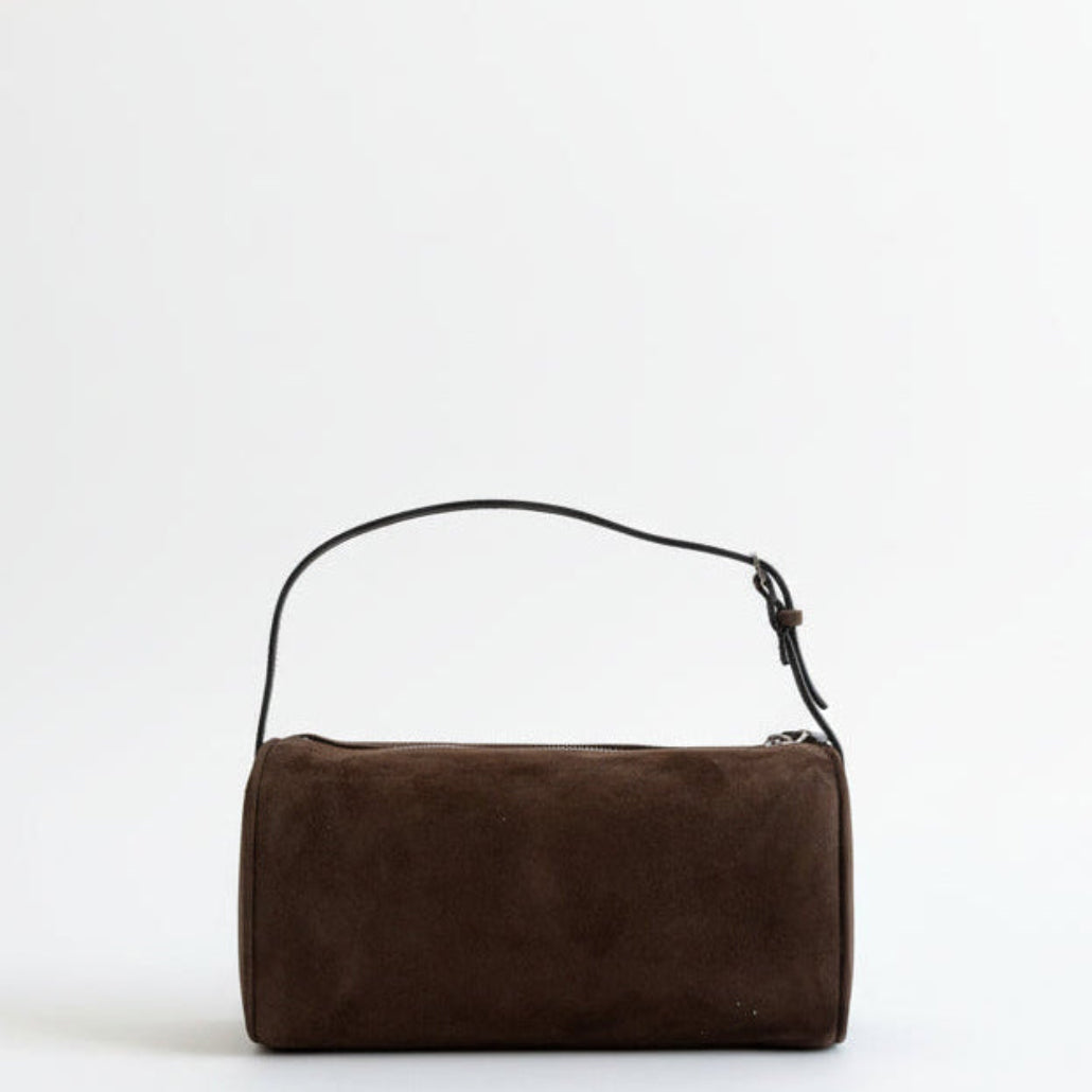 Brown suede handbag with a black strap on a white R:255 G:255, B:255 background