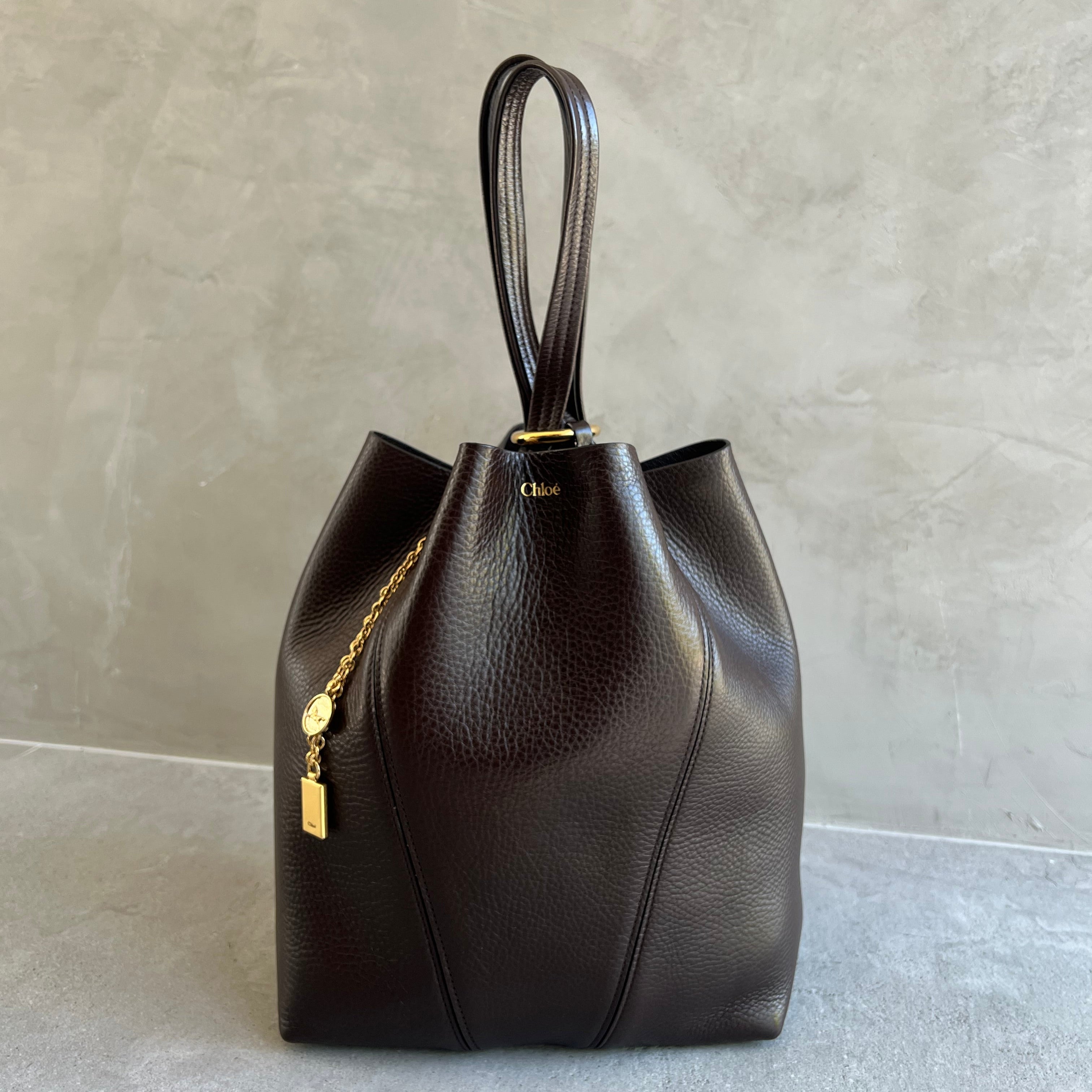 Brown leather handbag with gold accents 